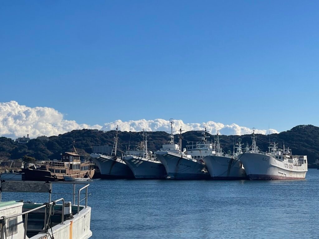 few japanese vessels docked in the sea.