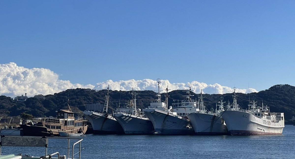 few japanese vessels docked in the sea.